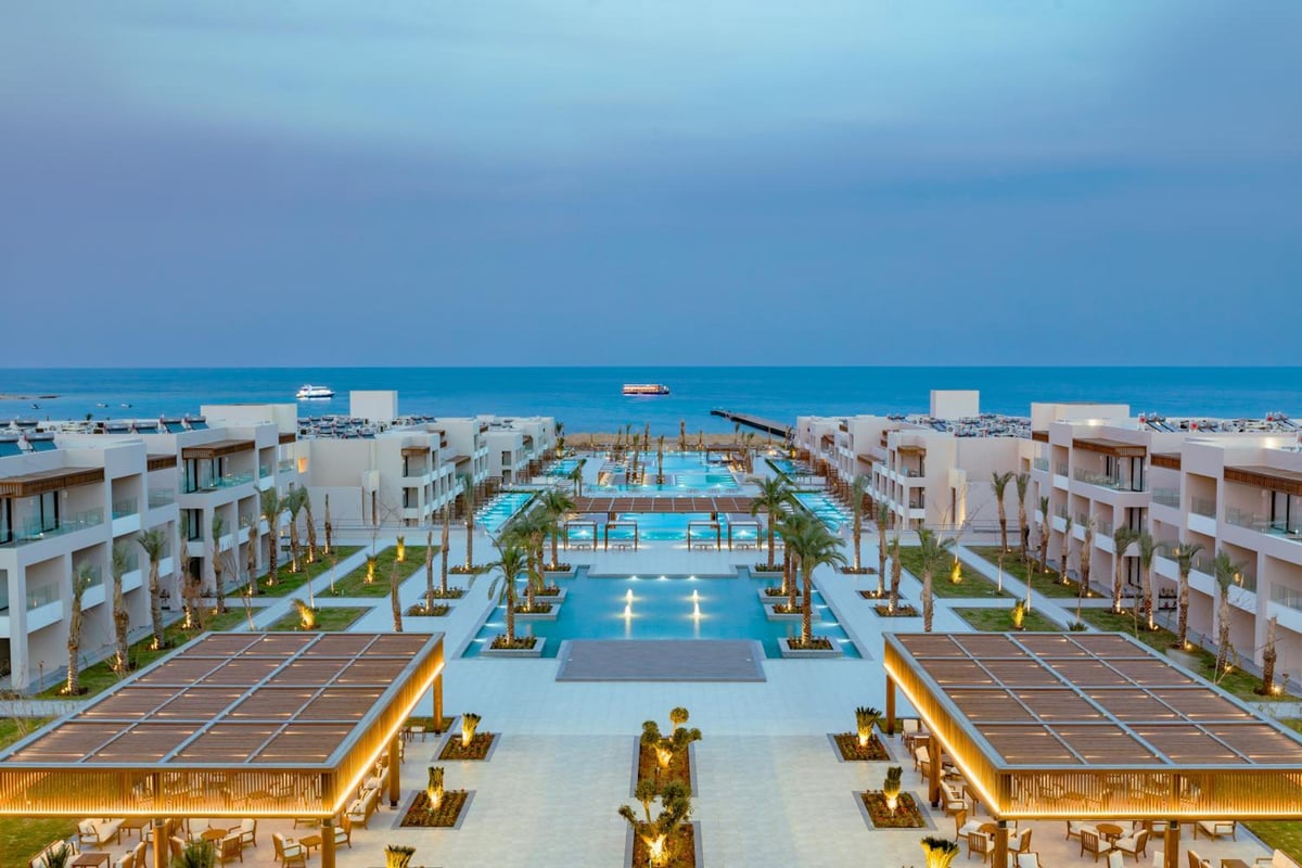 JAZ Elite Amara pool area with a long pool and the sea beyond.