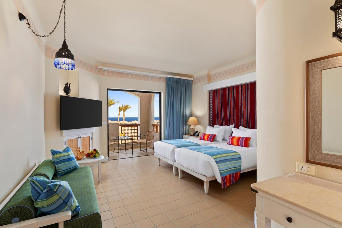Pickalbatros Sands Port Ghalib guest room with twin beds and a balcony.