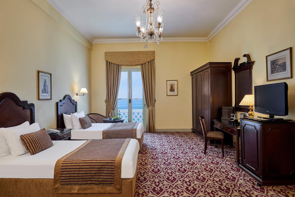 Steigenberger Cecil Hotel Alexandria twin bedroom with two beds and a sea view.