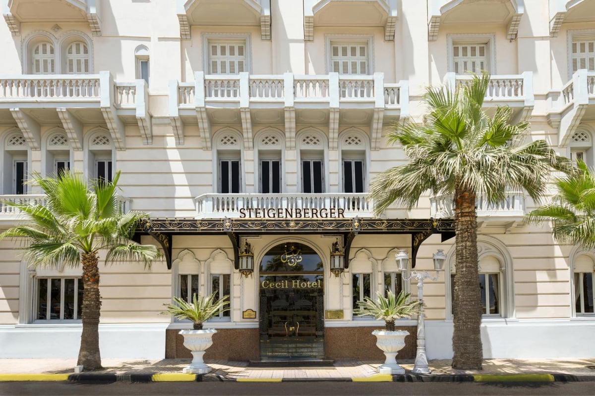 Steigenberger Cecil Hotel Alexandria entrance with an ornate canopy and palm trees.