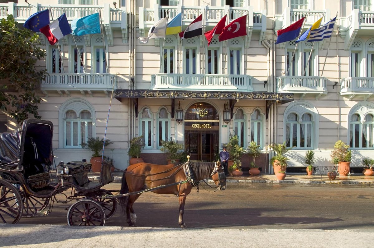 Steigenberger Cecil Hotel Alexandria entrance with a pale facade and a horse-drawn carriage.