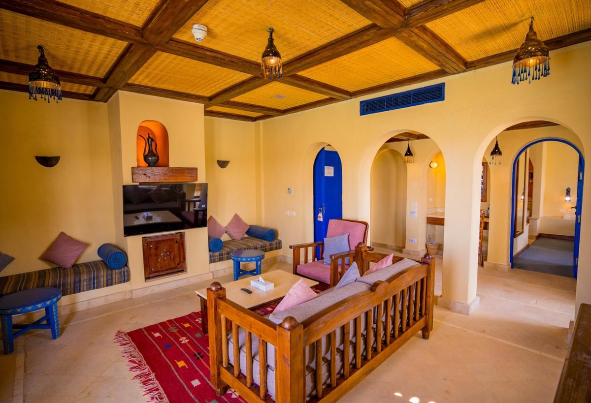Marina Lodge at Port Ghalib lounge with a wooden ceiling and arched doorways.