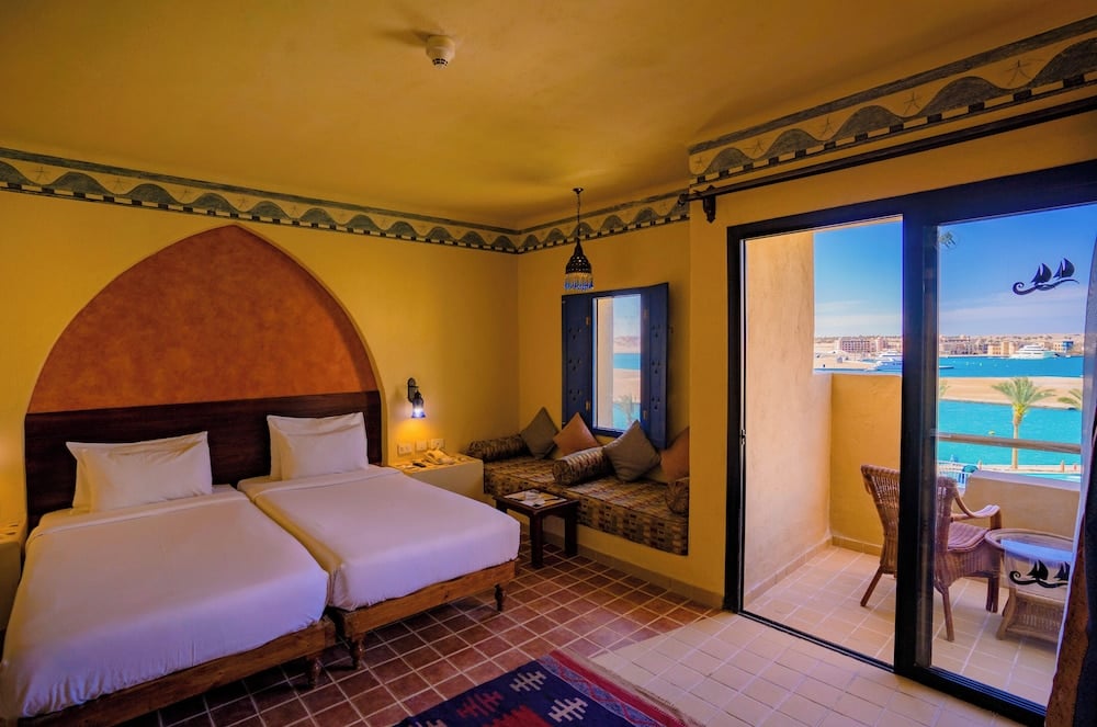 Marina Lodge at Port Ghalib guest room with twin beds and a balcony.