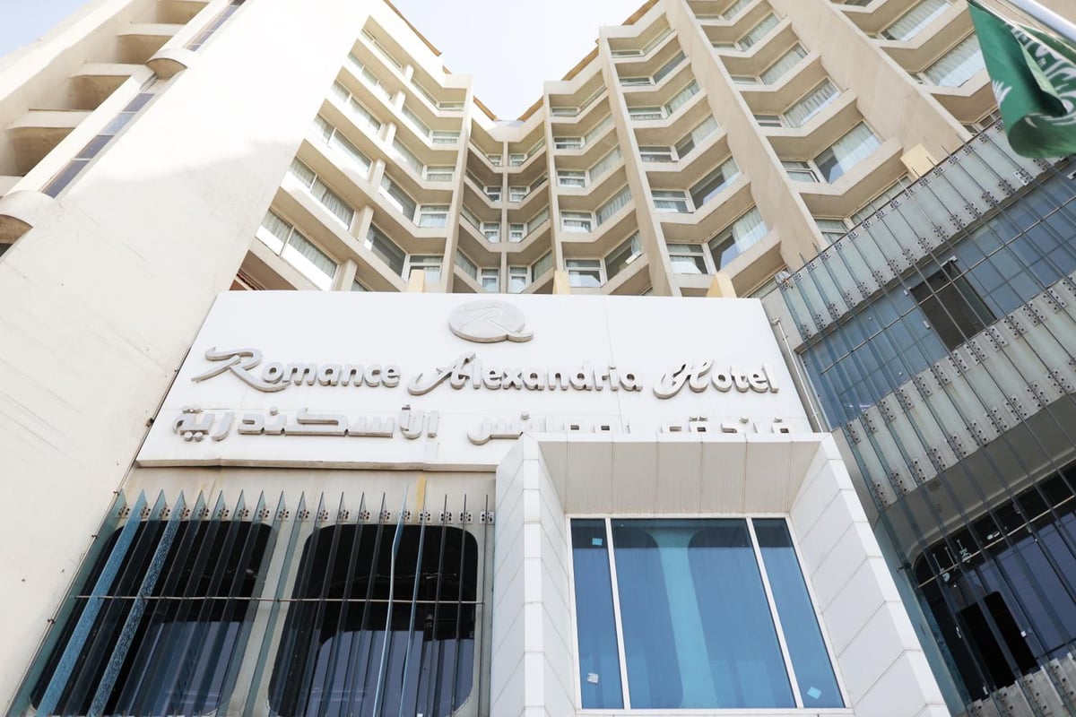 Romance Alexandria Hotel exterior with stacked balconies and a glass entrance.