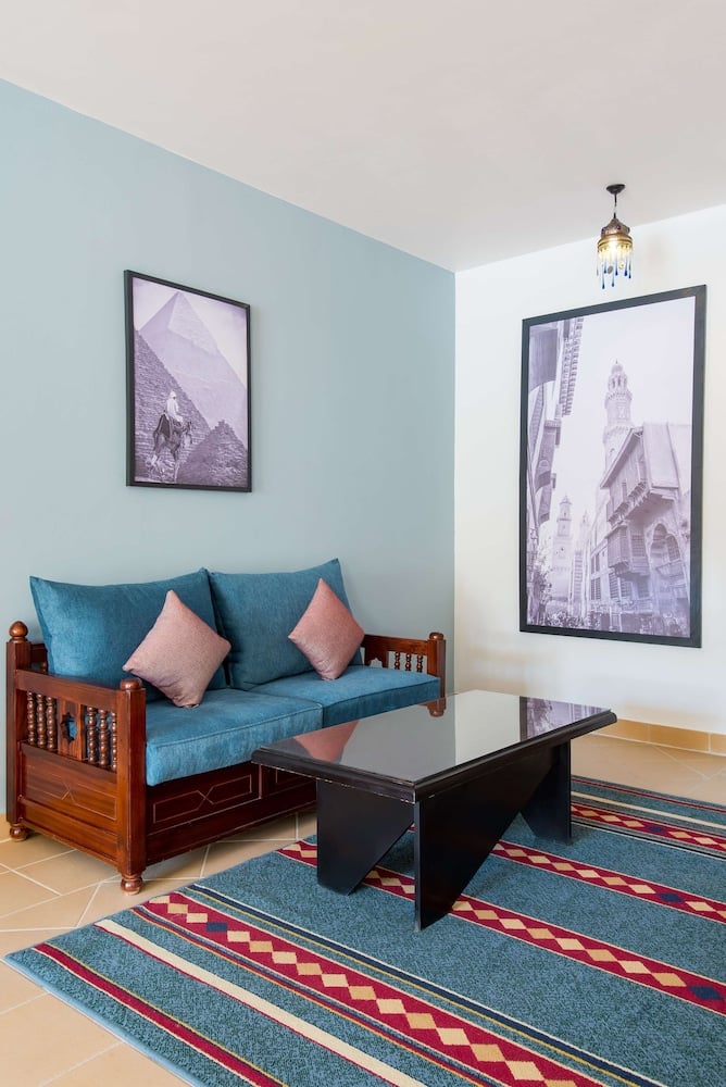 Marina Resort Port Ghalib sitting area with a teal sofa and patterned rug.