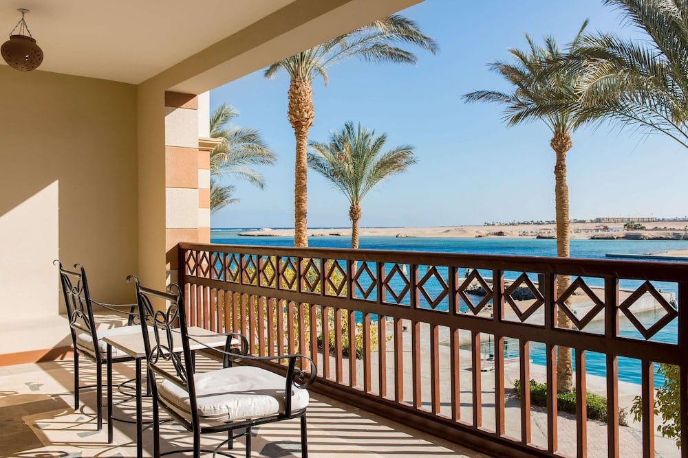 Marina Resort Port Ghalib balcony with a wooden railing and views of the pool and sea.