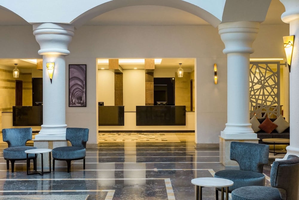 Marina Resort Port Ghalib lobby with columns and blue seating.