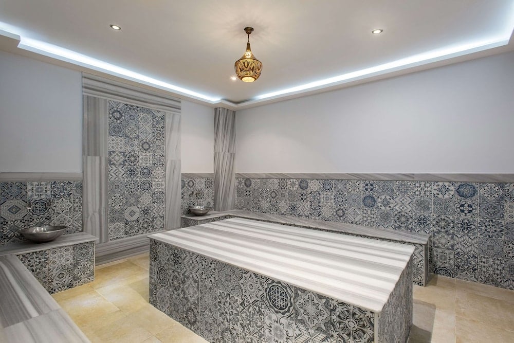 Marina Resort Port Ghalib treatment room with patterned tile walls and a central platform.
