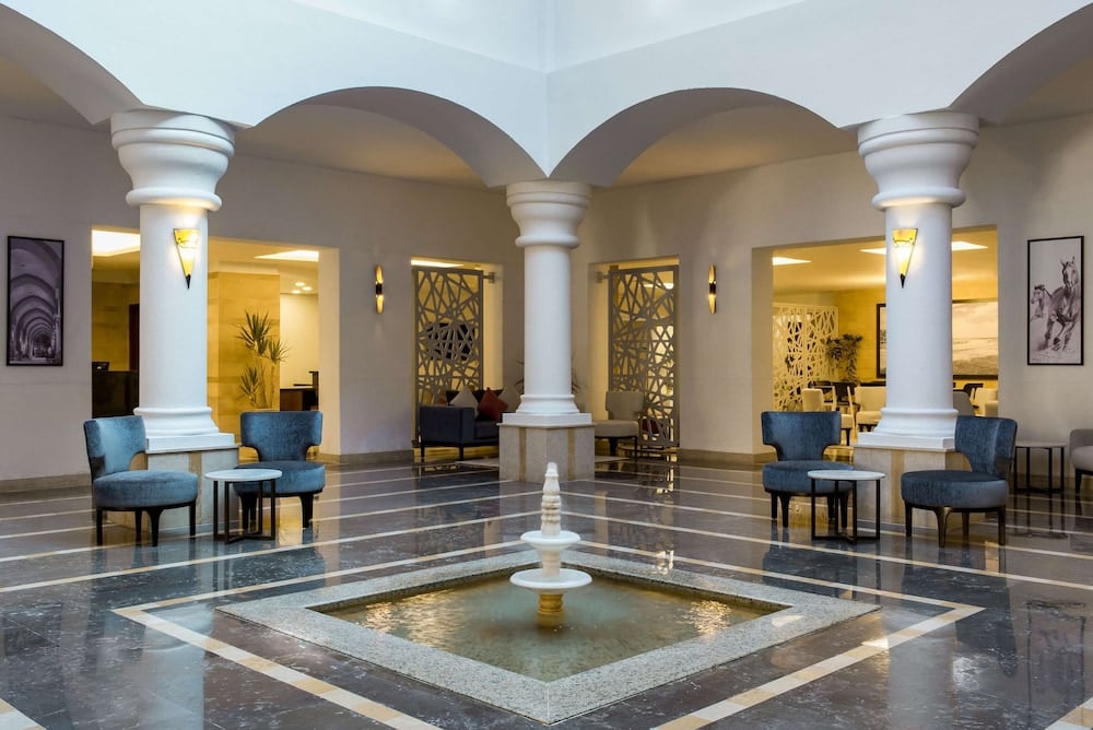 Marina Resort Port Ghalib lobby with white columns and a central fountain.