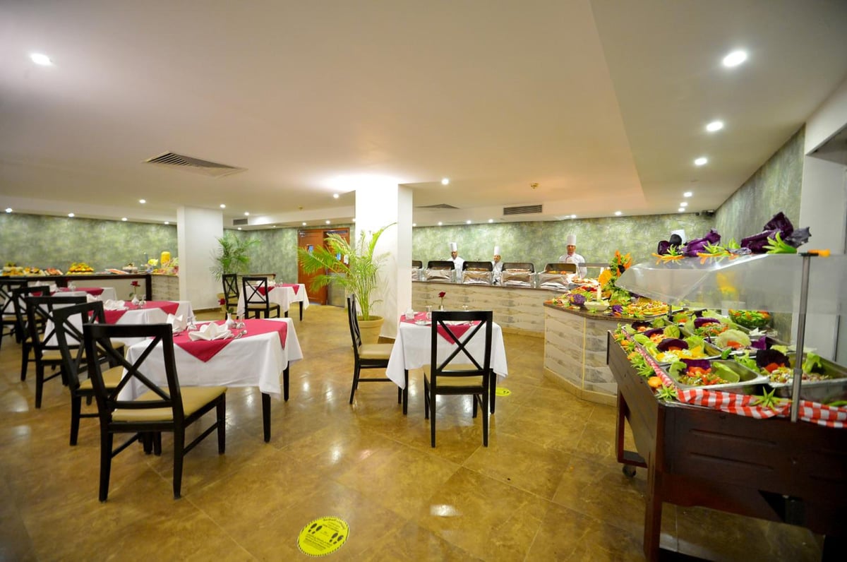 Falcon Naama Star Hotel dining room with buffet counters and tablecloth-covered tables.