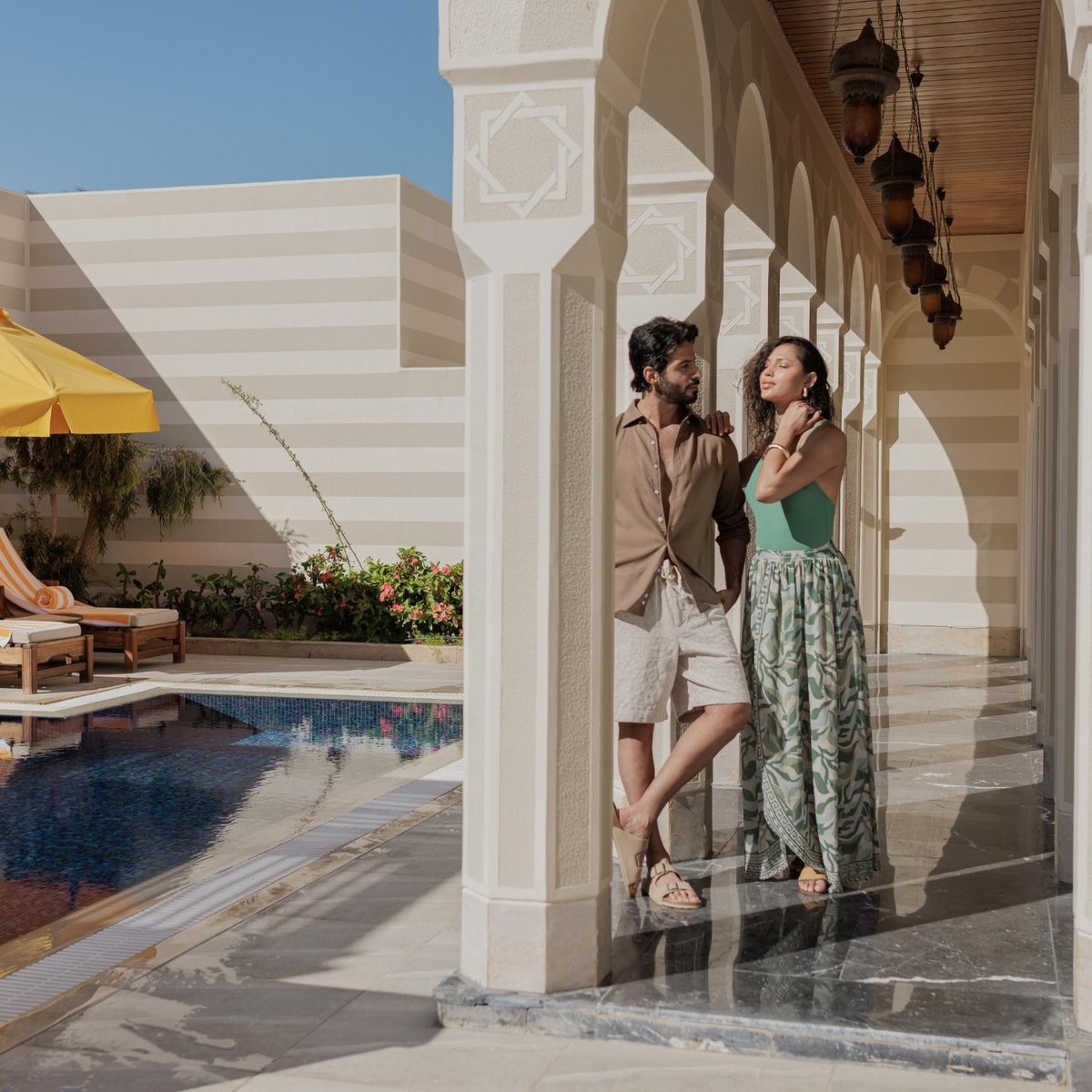The Oberoi Sahl Hasheesh poolside arcade with patterned columns and a swimming pool.