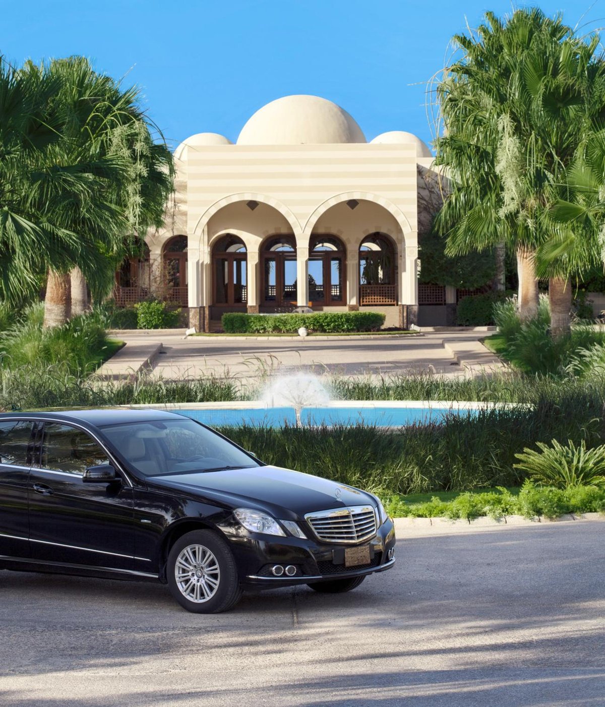 The Oberoi Sahl Hasheesh hotel entrance with an arched portico and domed roof.