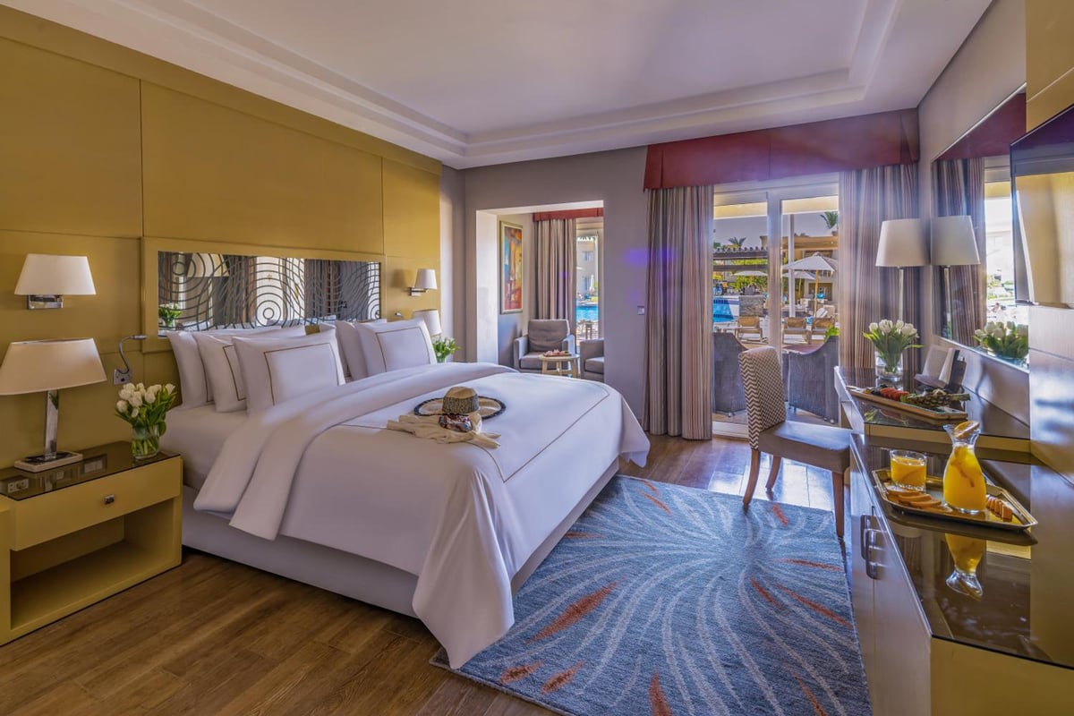 Rixos Premium Seagate guest room with a large bed and a balcony.