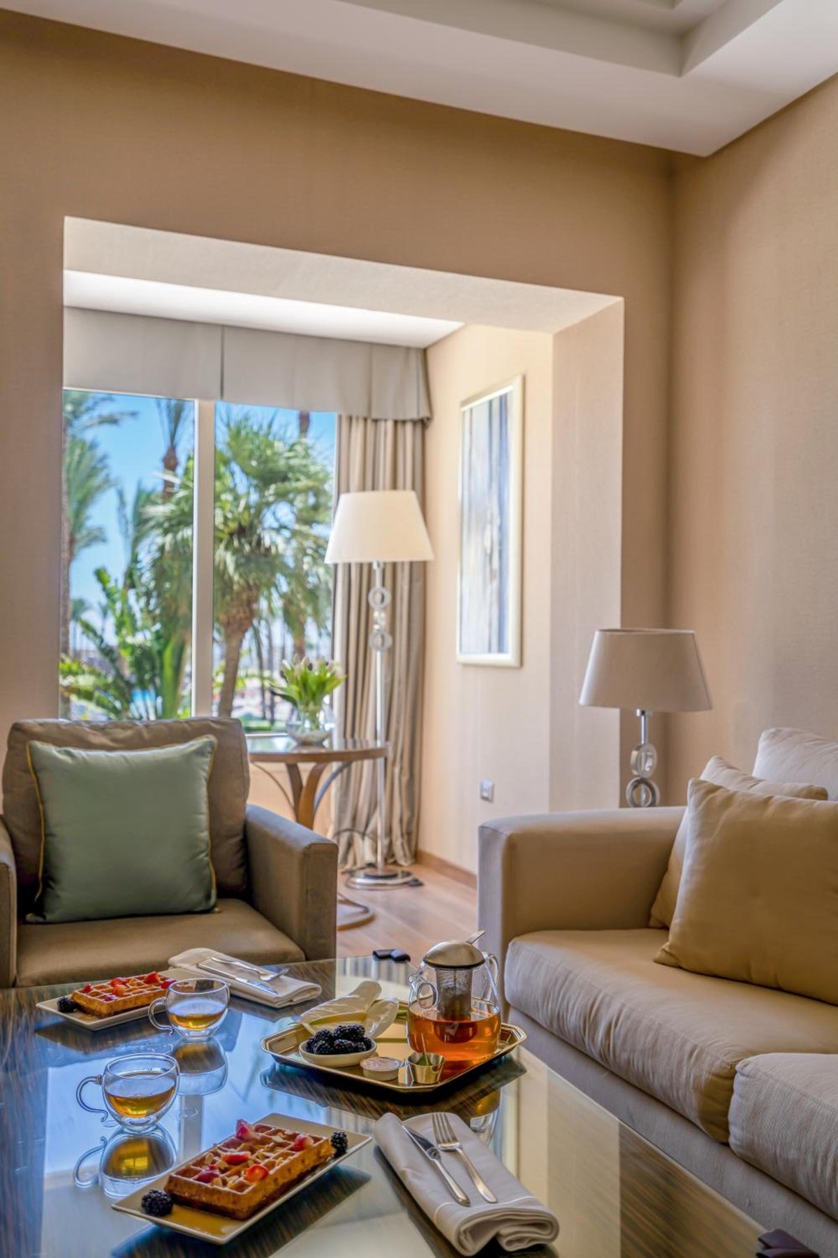 Rixos Premium Seagate lounge with sofas and tall windows.