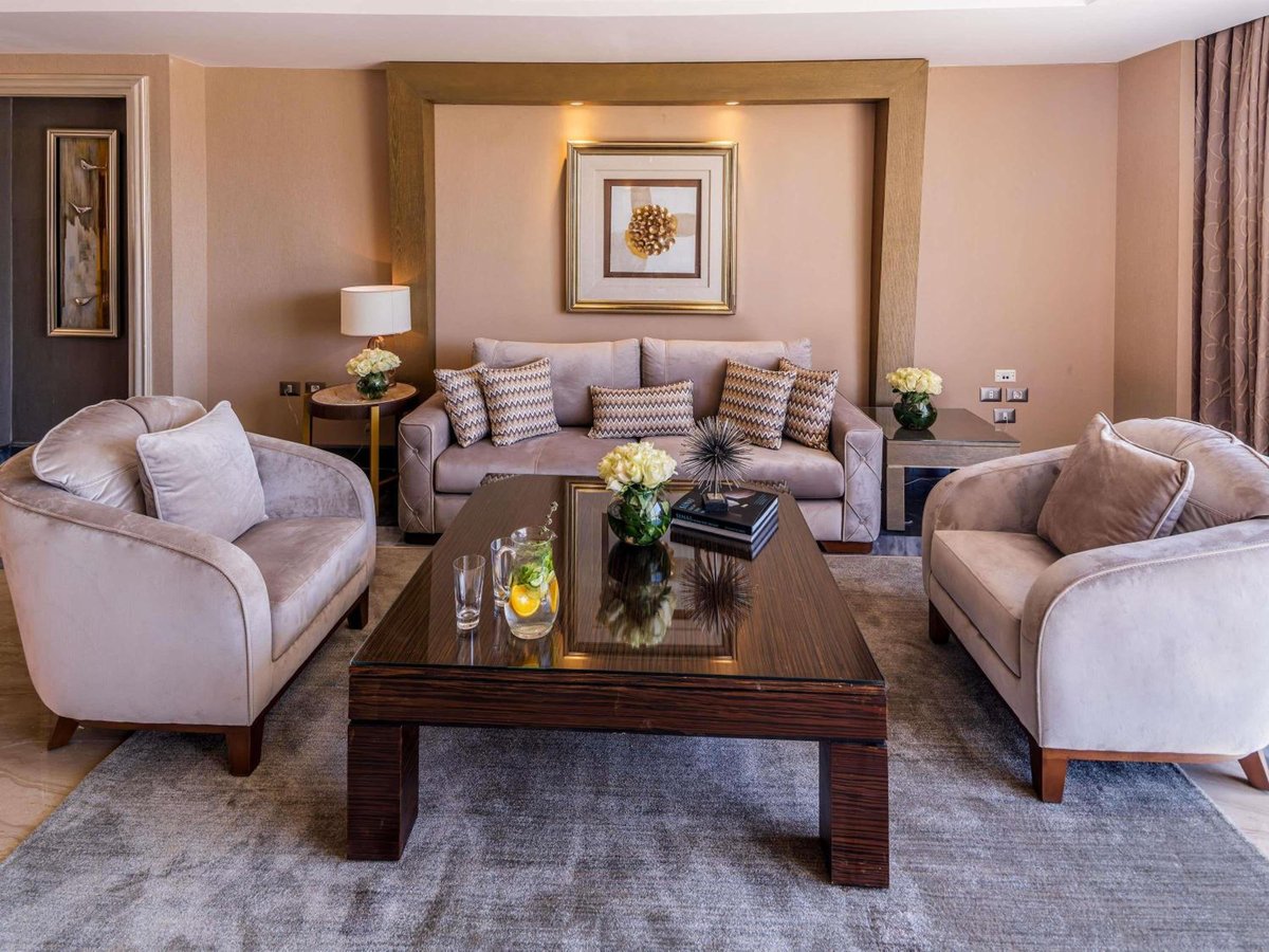 Rixos Premium Seagate suite living room with sofa seating and a coffee table.