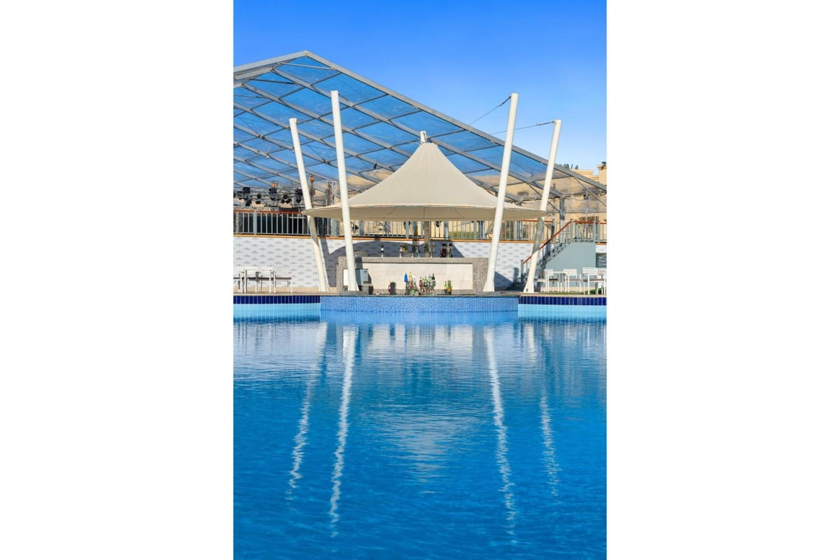 Rixos Premium Seagate pool with a fabric canopy and a metal shade structure.