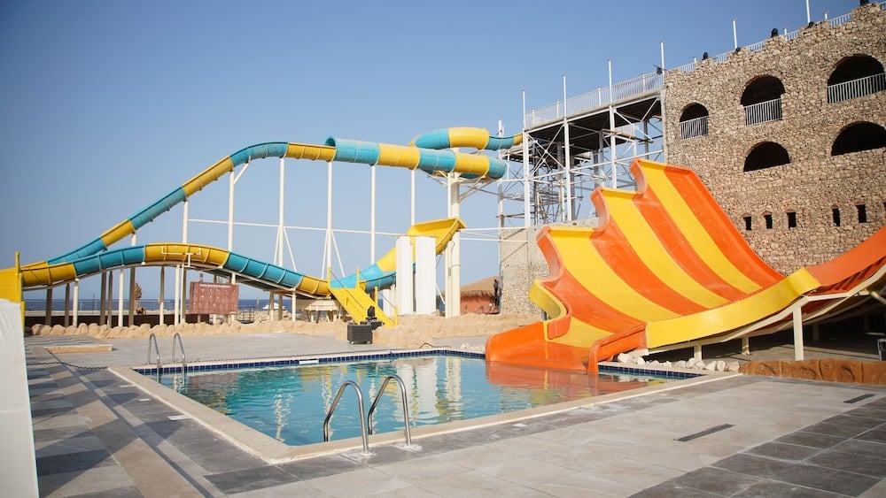 Amarina Jannah Resort & Aqua Park water park pool with blue water and colorful slides.