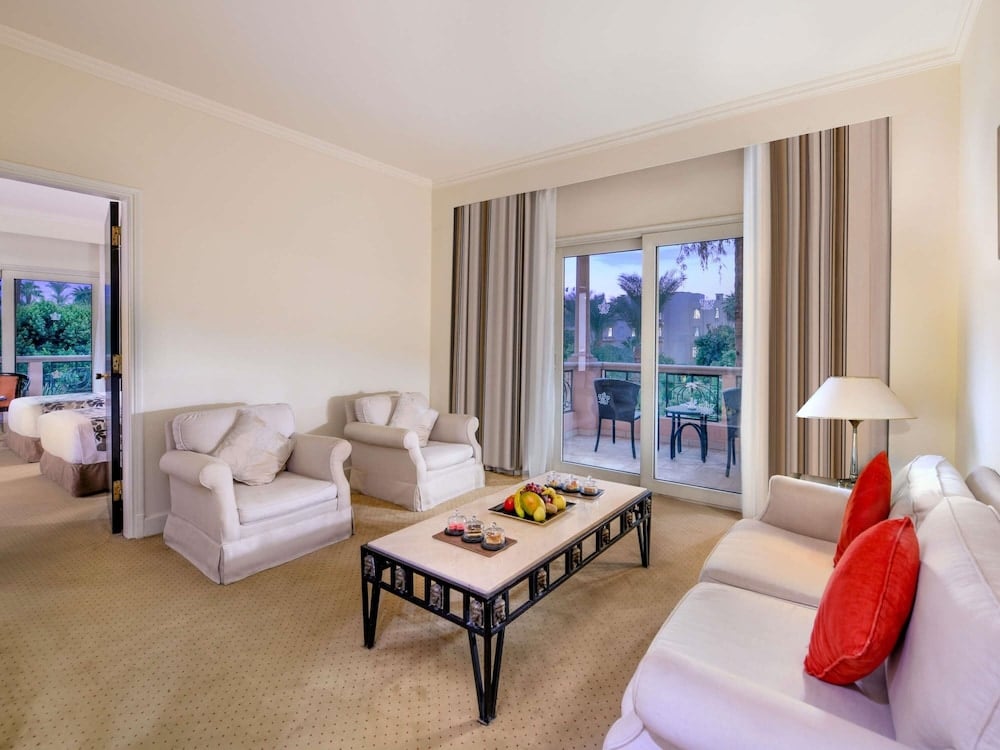 Pavillon Winter Luxor living room with pale seating and balcony doors.