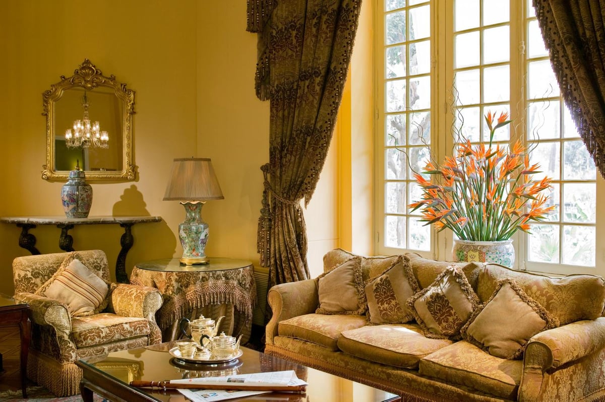 Pavillon Winter Luxor lounge with a tall window and upholstered sofas.