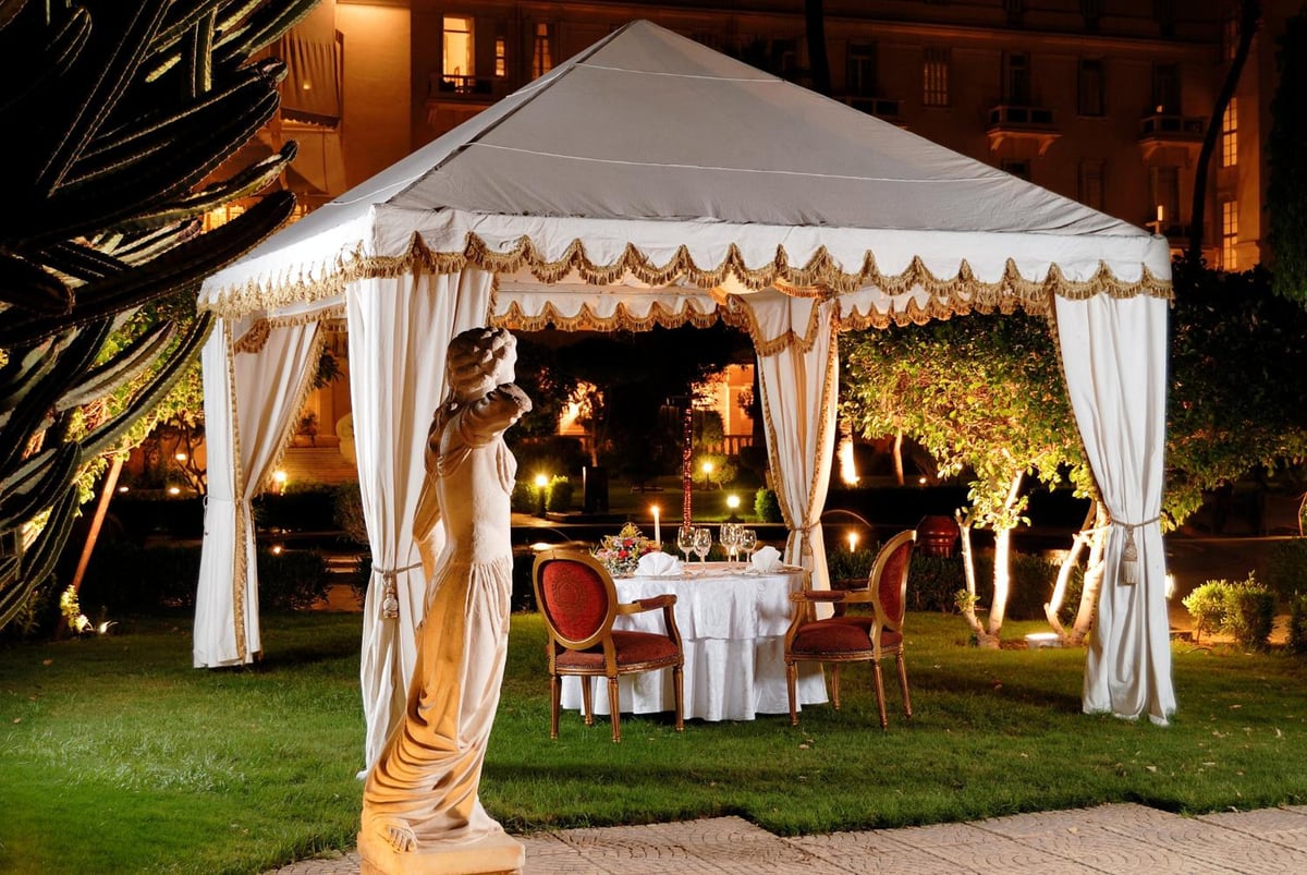 Pavillon Winter Luxor garden dining tent with draped canopy and dining table.
