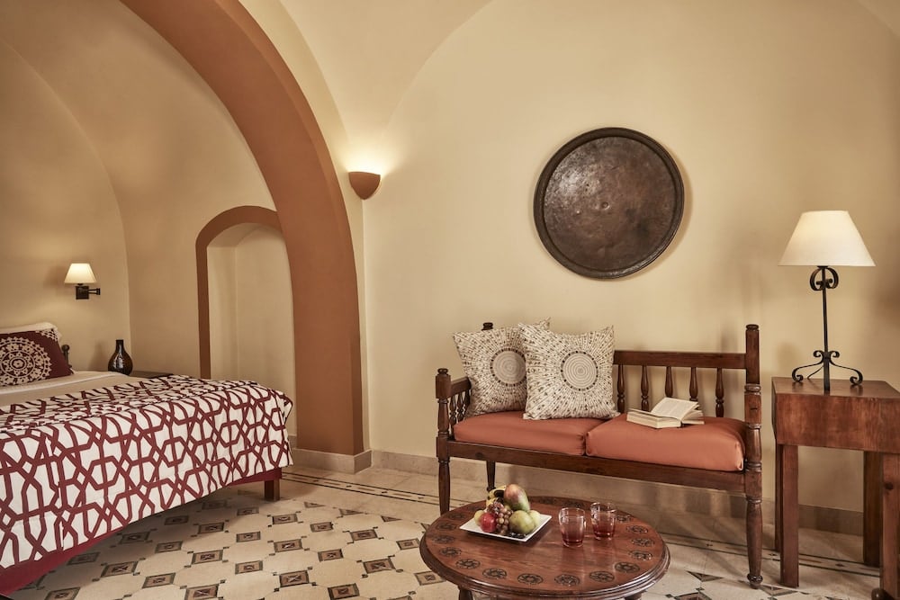Dawar El Omda Hotel El Gouna (Adults Only) guest room with a patterned bed and an arched doorway.
