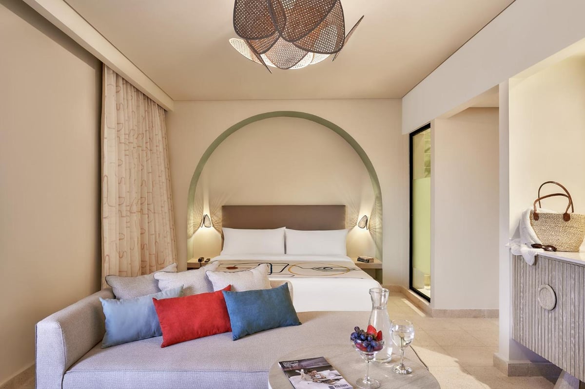 Three Corners Ocean View El Gouna (Adults Only) guest room with a bed and a sofa.