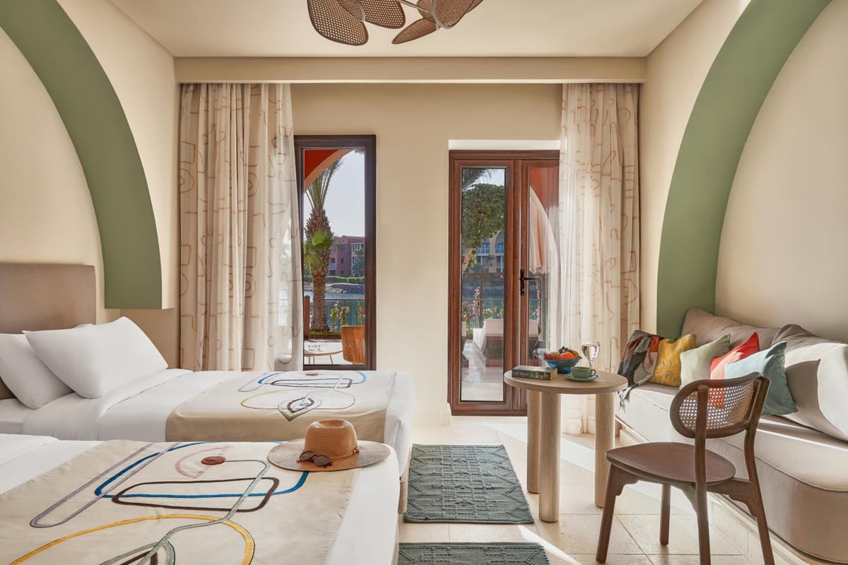 Three Corners Ocean View El Gouna (Adults Only) bedroom with twin beds and balcony doors.