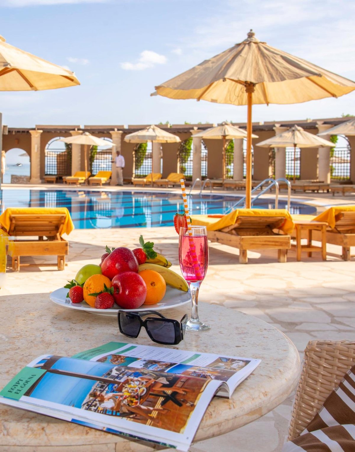Three Corners Ocean View El Gouna (Adults Only) poolside terrace with a swimming pool and shaded loungers.