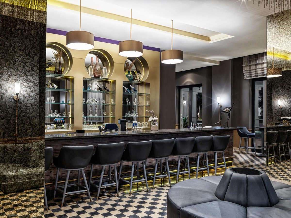 Ancient Sands Golf Resort bar with a long counter and circular display niches.