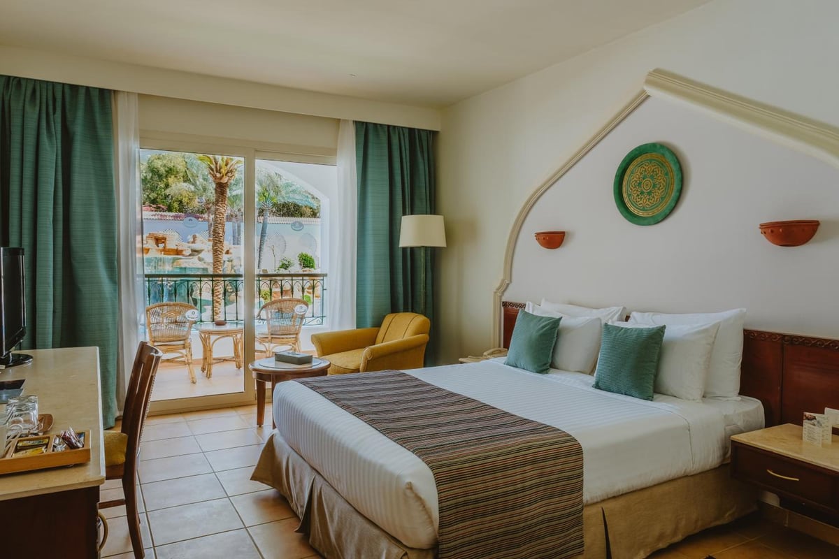 Baron Palms Resort (Adults Only) guest room with a bed and balcony.