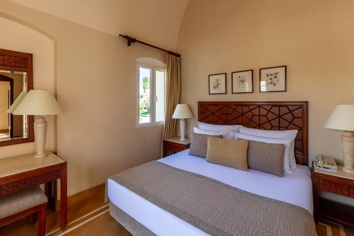 Iberotel Makadi Beach guest bedroom with a patterned headboard and arched ceiling.
