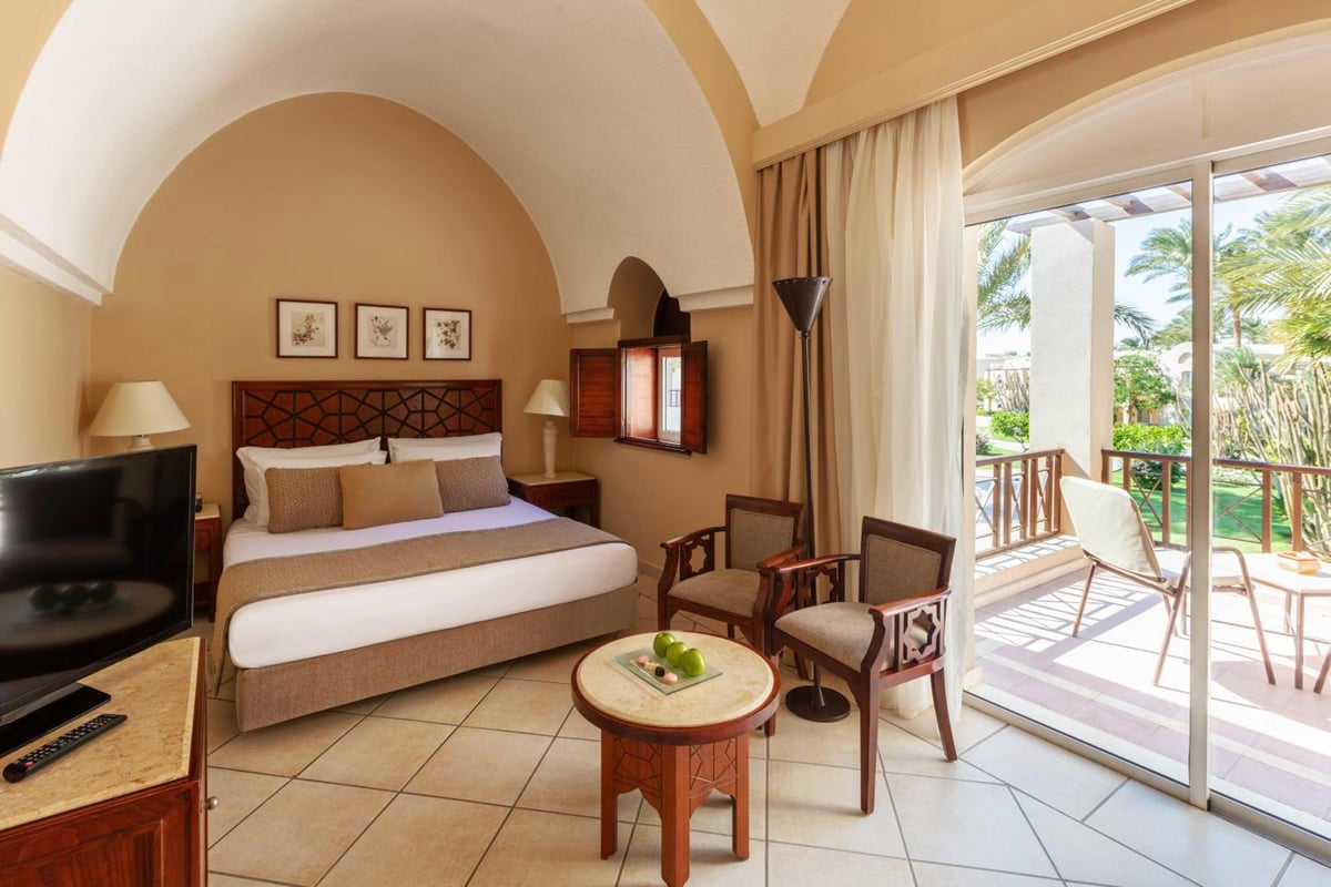 Iberotel Makadi Beach guest room with an arched ceiling and a balcony.
