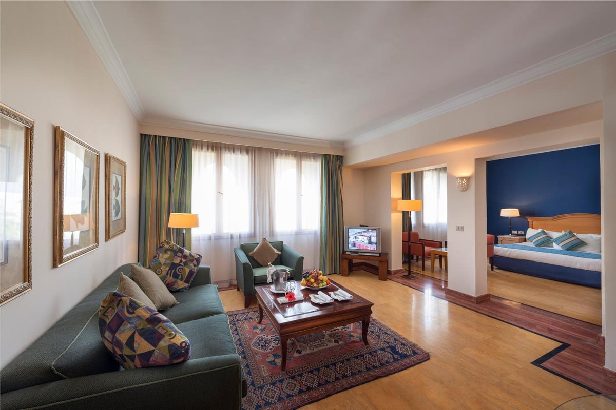 Reef Oasis Beach Aqua Park Resort living room with a sofa and adjoining bedroom.