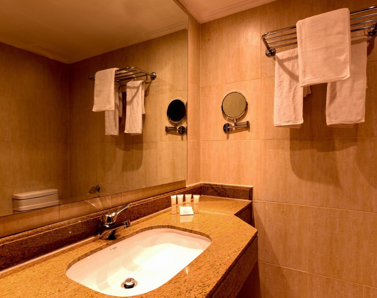 The Grand Plaza Hotel Smouha bathroom with a sink and towel racks.
