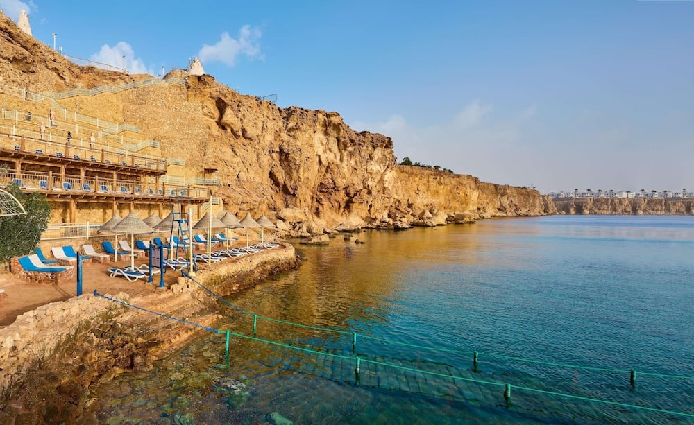 Dreams Beach - Sharm El Sheikh cliffside beach with terraced platforms and clear sea.
