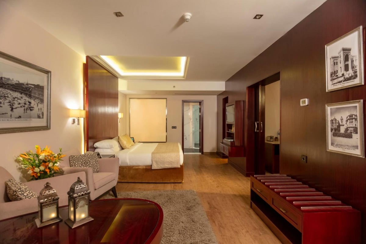 Royal Savoy Sharm El Sheikh suite with a bed and sitting area.