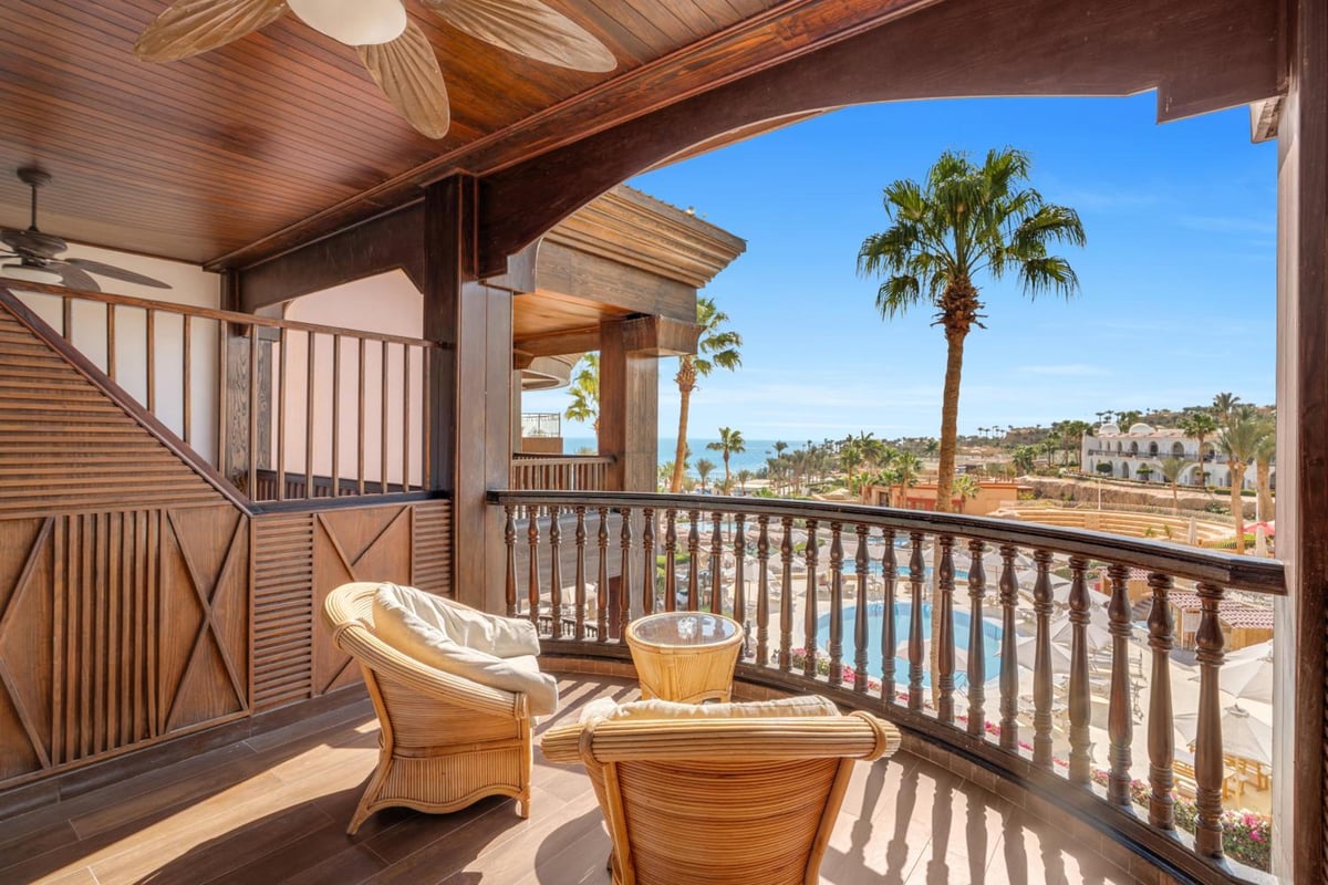 Royal Savoy Sharm El Sheikh covered balcony with wooden railings and a sea view.