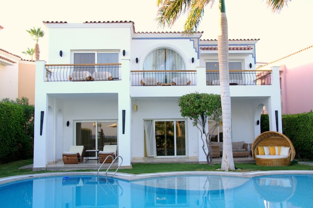 Royal Savoy Sharm El Sheikh villa exterior with a pool and balconies.