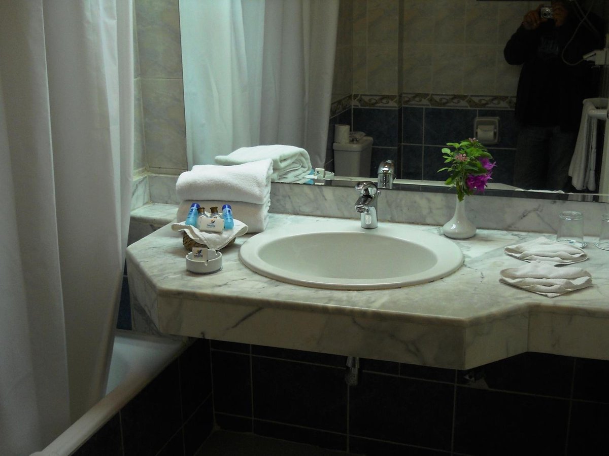 Turquoise Beach Hotel bathroom vanity with a marble counter and oval sink.