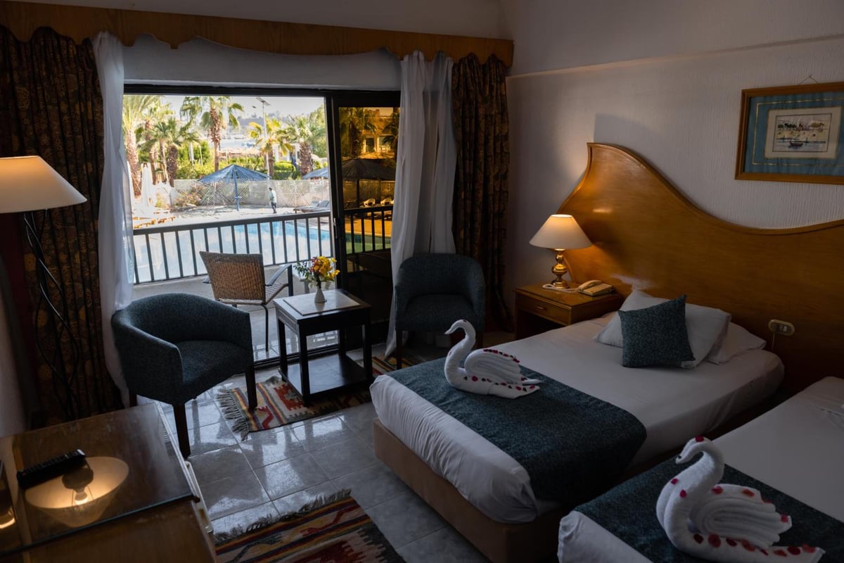 Turquoise Beach Hotel twin bedroom with twin beds and a balcony.