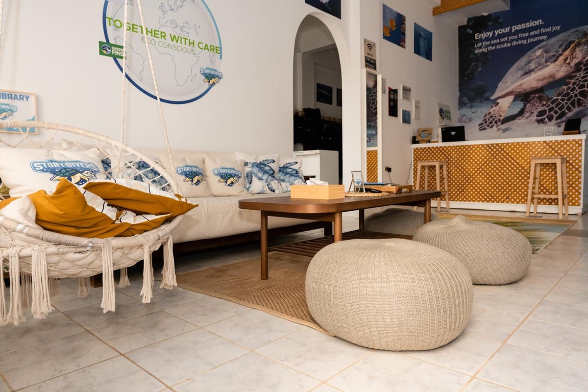 Turquoise Beach Hotel lounge with a cushioned sofa and woven poufs.