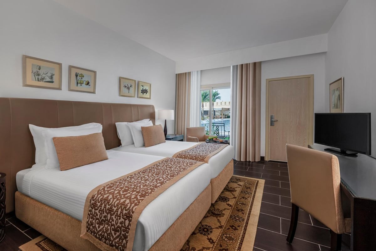 Steigenberger Makadi (Adults Friendly 16+) guest room with twin beds and balcony doors.