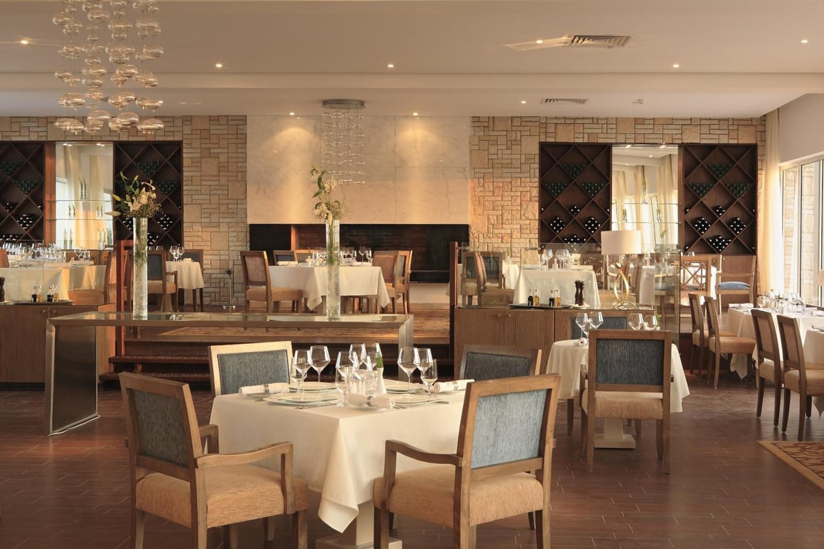 Steigenberger Makadi (Adults Friendly 16+) restaurant with set tables and brick-patterned walls.
