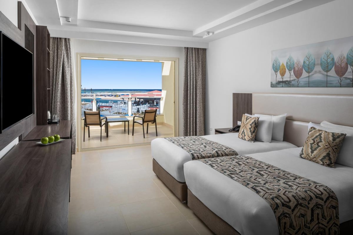 Albatros Makadi Resort bedroom with twin beds and a balcony.