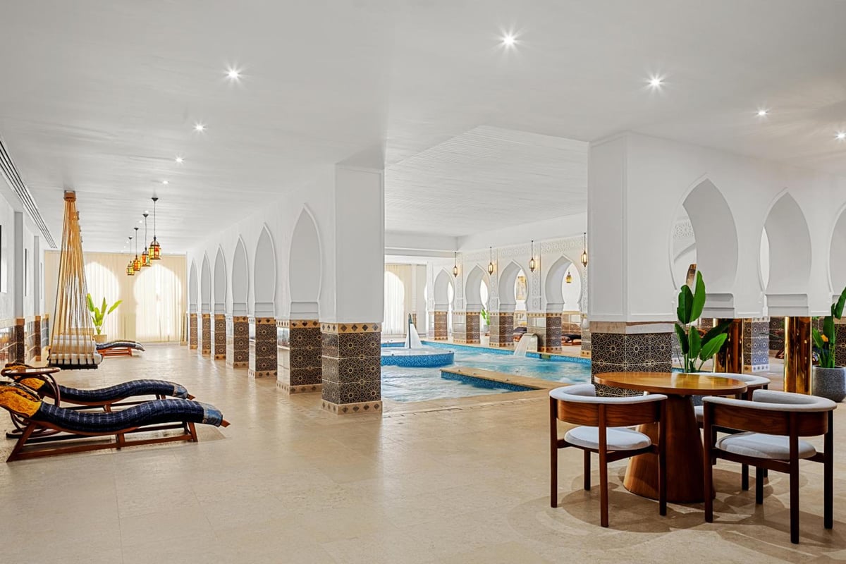 Albatros Makadi Resort indoor pool area with arched columns and loungers.