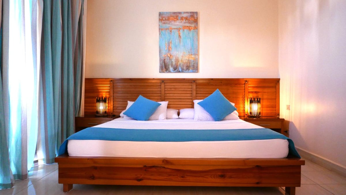 Sheikh Ali Dahab Resort bedroom with blue bedding and a wooden headboard.