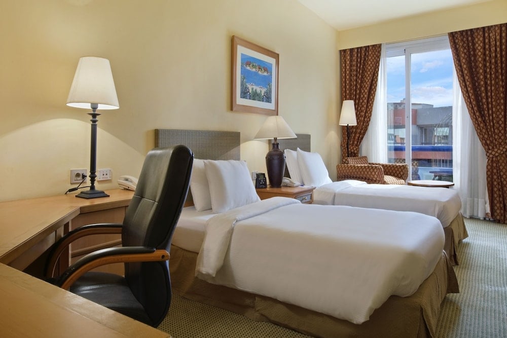 Hilton Alexandria Green Plaza twin room with two beds and a desk.