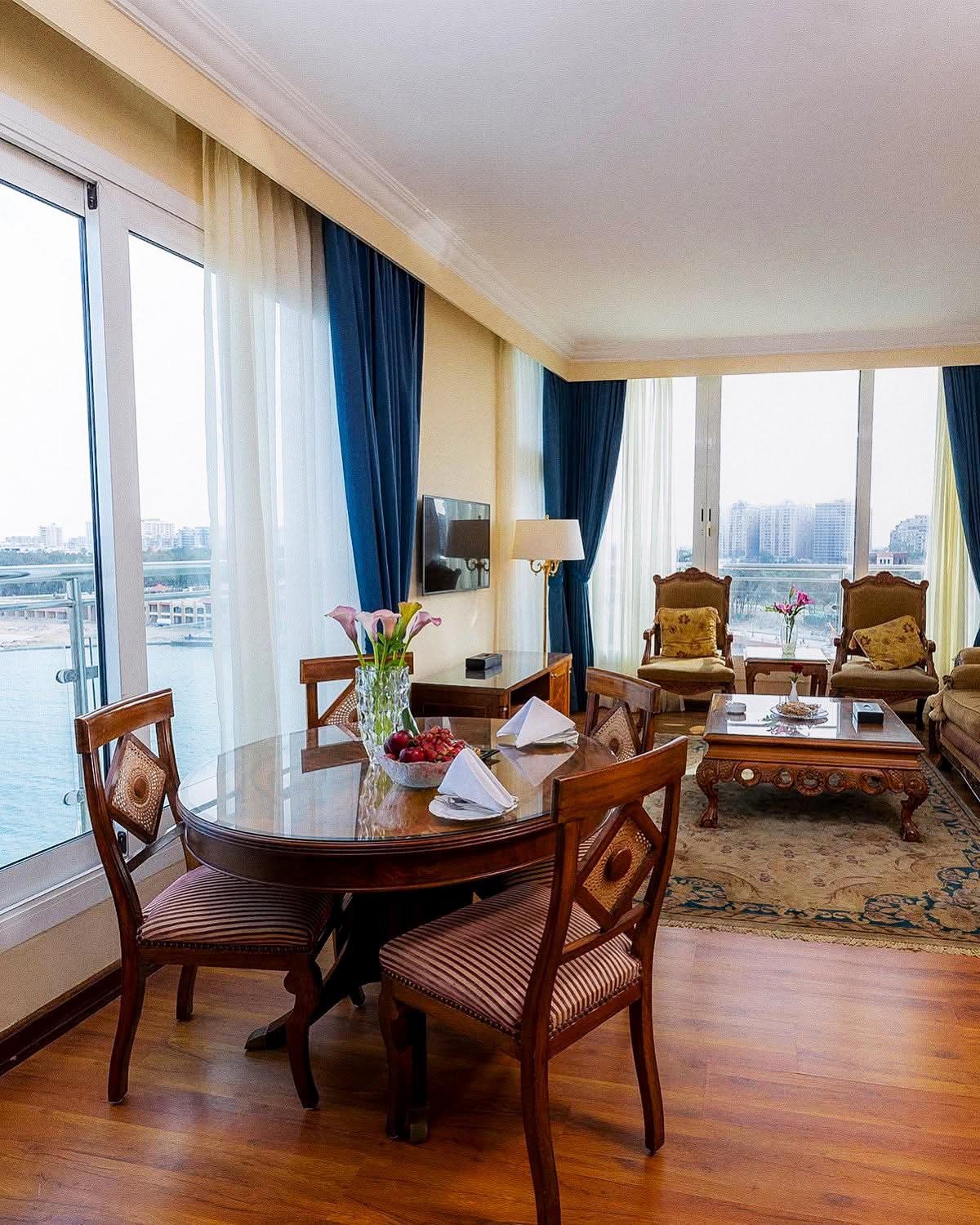 Palestine Montaza Alexandria suite living area with a dining table and lounge seating.