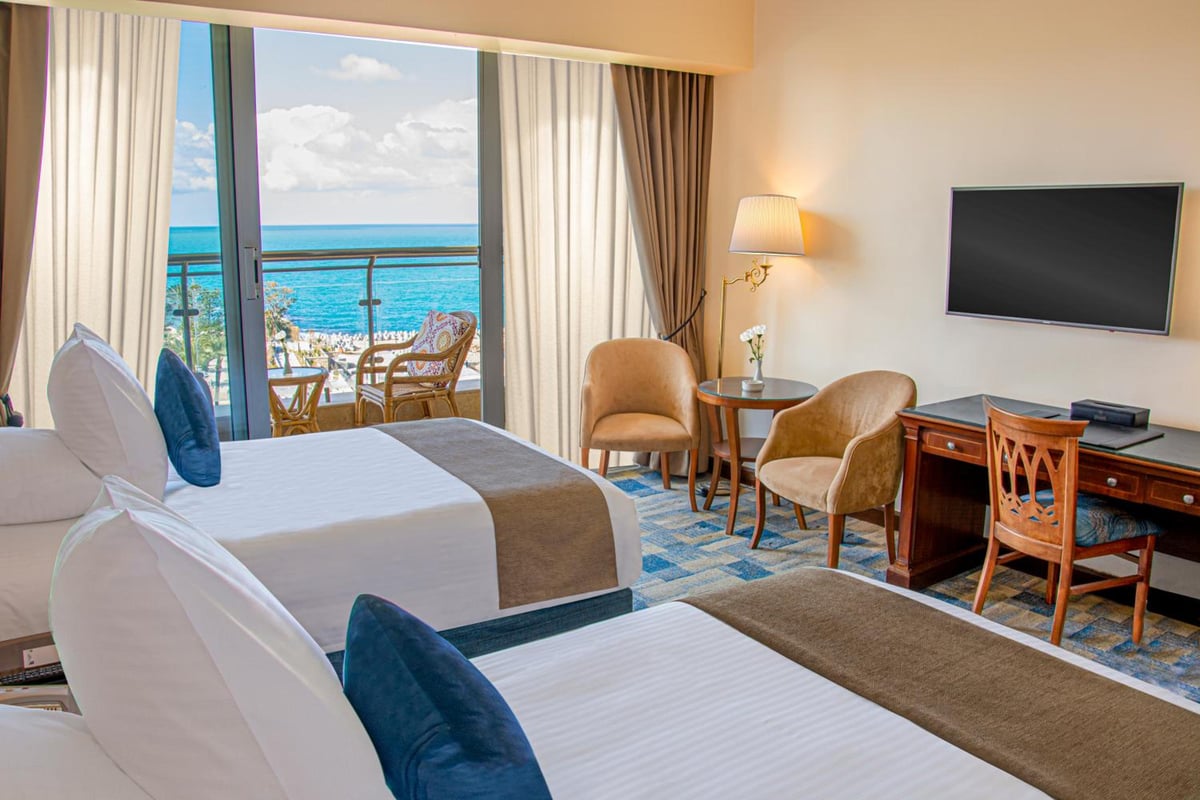 Palestine Montaza Alexandria guest room with two beds and a sea-view balcony.