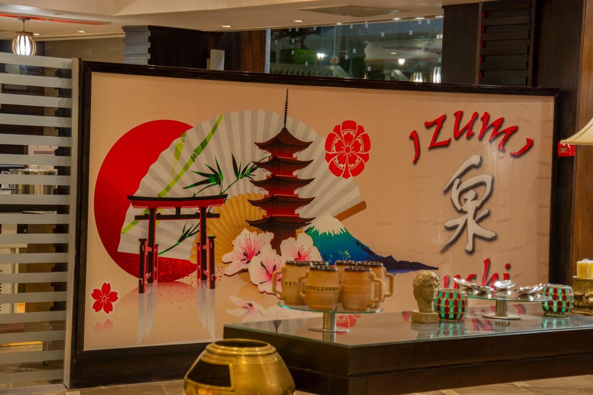 Palestine Montaza Alexandria restaurant entrance with a Japanese mural and glass display counter.